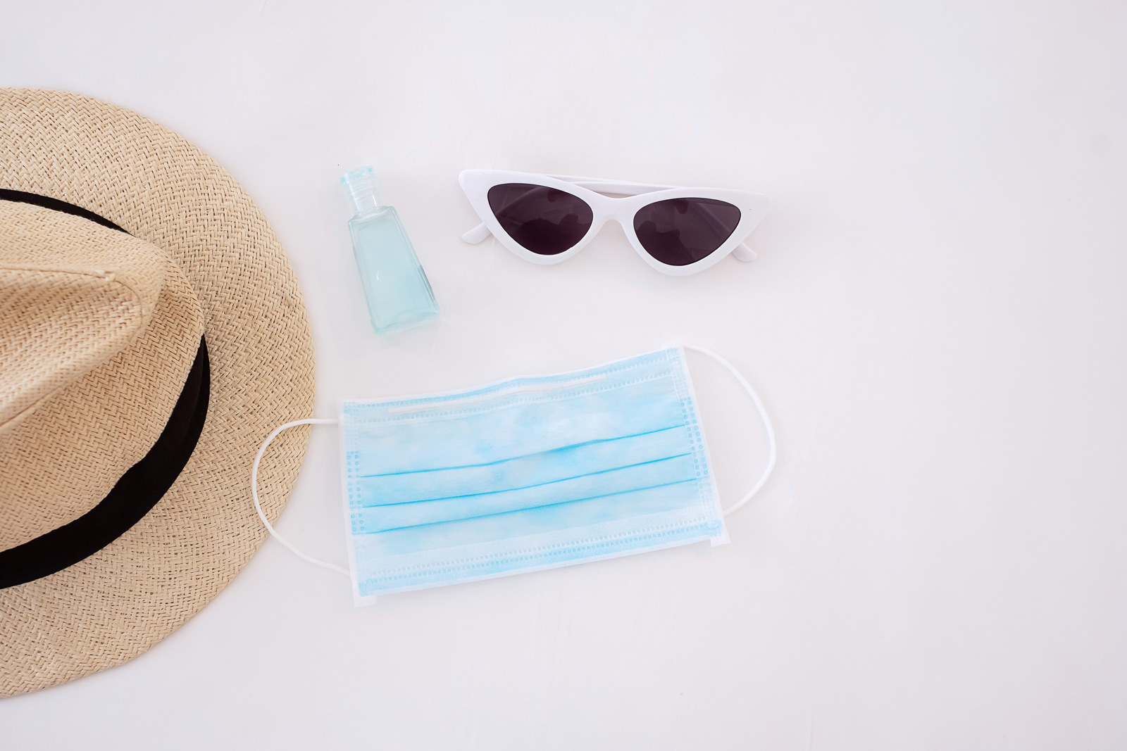 Medical mask sanitizer sunglasses and a hat